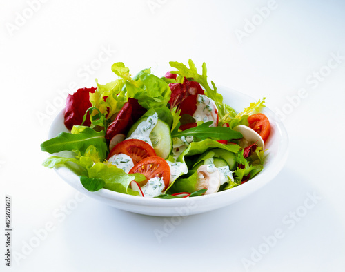 Salad with tomato, radishes, and dressing