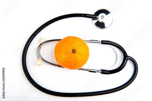 Stethoscope and Mandarin on white background