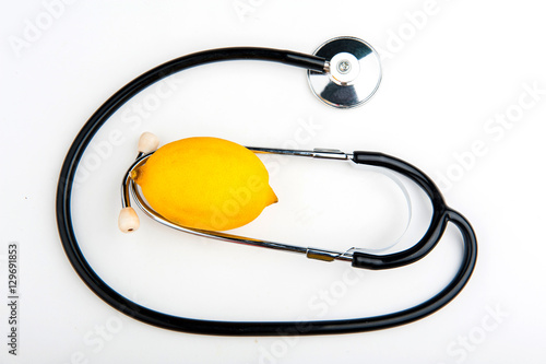 Stethoscope and lemon on a white background