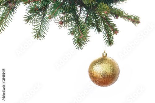 Gold glitter Christmas baubles hanging from the branch of a fir
