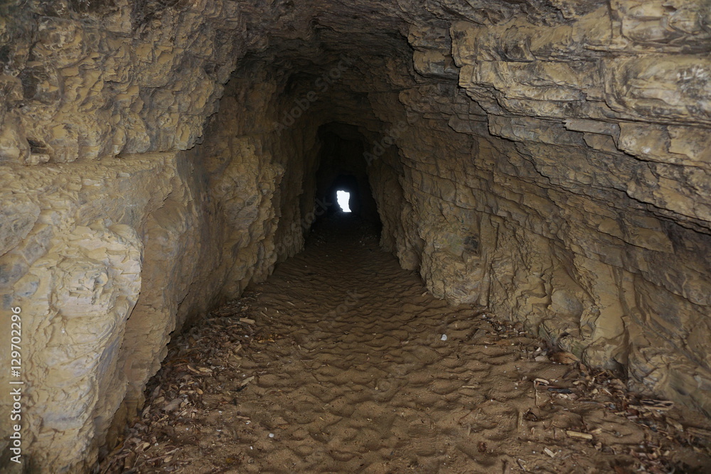Inside a small tunnel in the rock connecting beaches of La Roche Percee to Turtle Bay, Bourail, Grande Terre, New Caledonia, south Pacific
