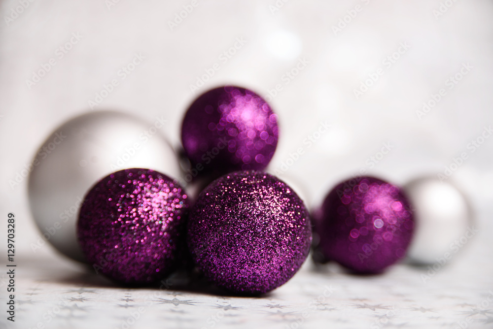 Purple Sparkling and Silver Christmas balls Close-up on a soft focus light background. horizontally holiday banner Purple Sparkling and Silver Christmas balls Close-up on a soft focus light background. horizontally holiday banner