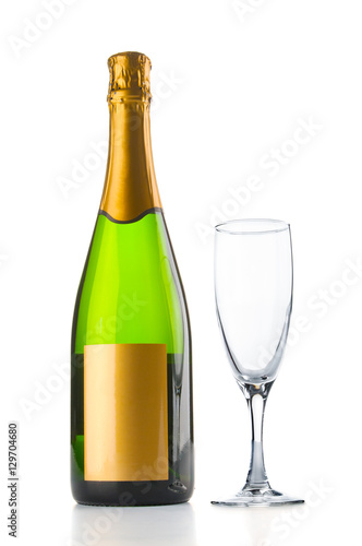 Champagne bottle and empty goblet on white background