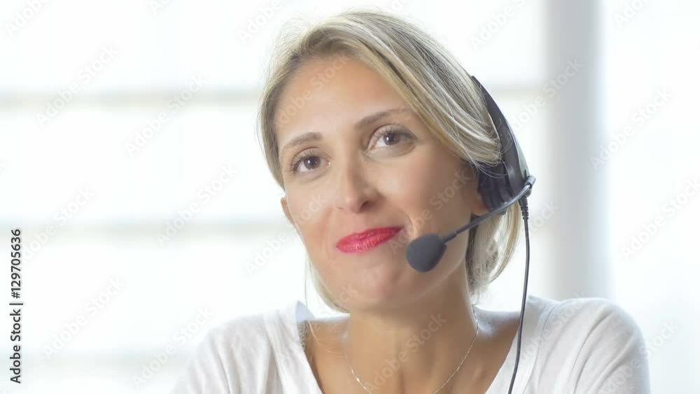 Female customer support operator with headset and smiling. 4K Female customer support operator with headset and smiling. 4K