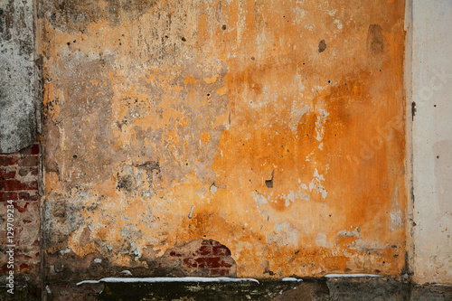 Natural design frame with brick and concrete wall. Background texture of old concrete surfaces, plaster falling off. Vintage grunge style