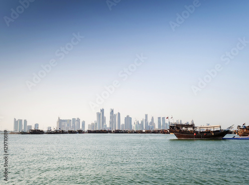 doha city urban skyline view and dhow boat in qatar
