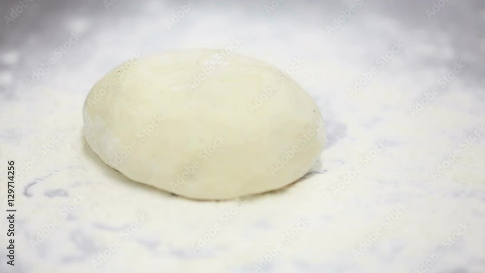 Baker throwing flour and dough on the table Baker throwing flour and dough on the table