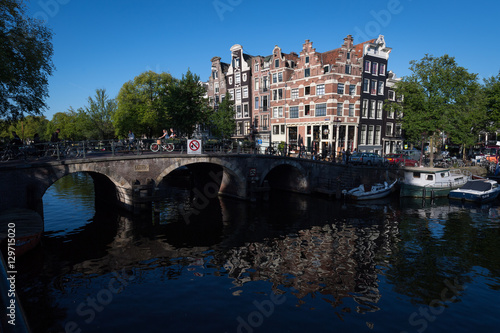 Crooked buildings in the early morning summer sun on the corner of the Browersgracht and Prinsengracht, Amsterdam, Netherlands