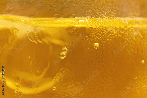 cold cider drink with ice in glass close up