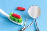 concept tooth pain - dentist tools, tablet at blue background
