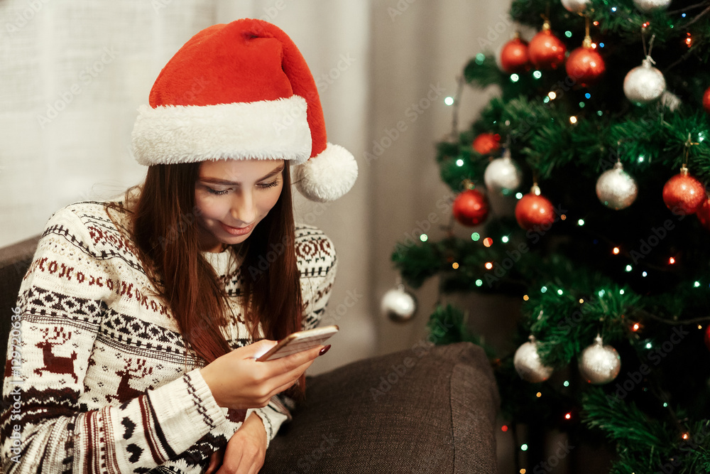 christmas advertising concept. stylish woman holding phone looki christmas advertising concept. stylish woman holding phone looki