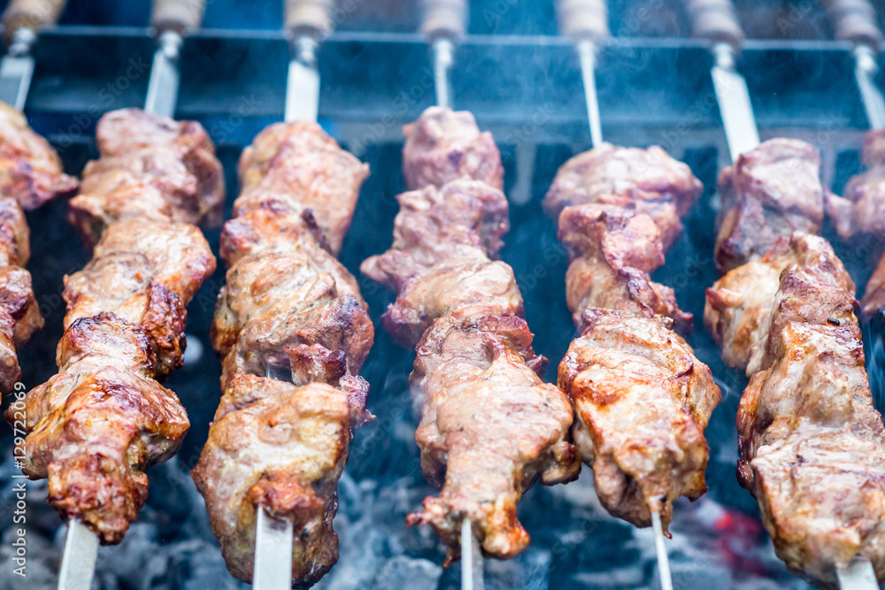 delicious meat on skewers cooked on fire