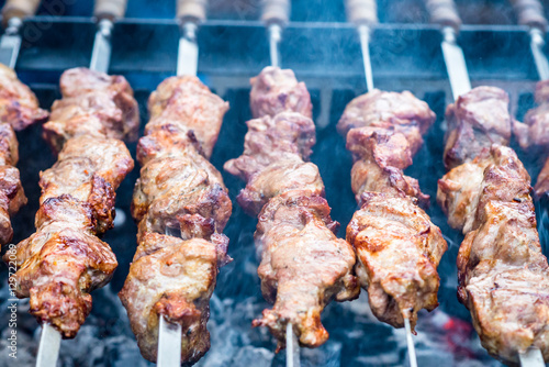 delicious meat on skewers cooked on fire