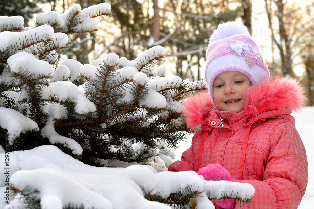 child, kid,t ouching ,watching the snow on the tree in winter child, kid,t ouching ,watching the snow on the tree in winter