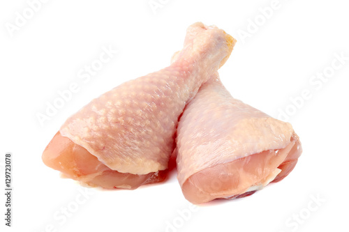 Raw chicken legs on white