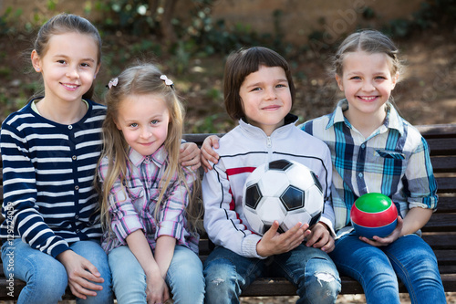 Kids posing together with ball