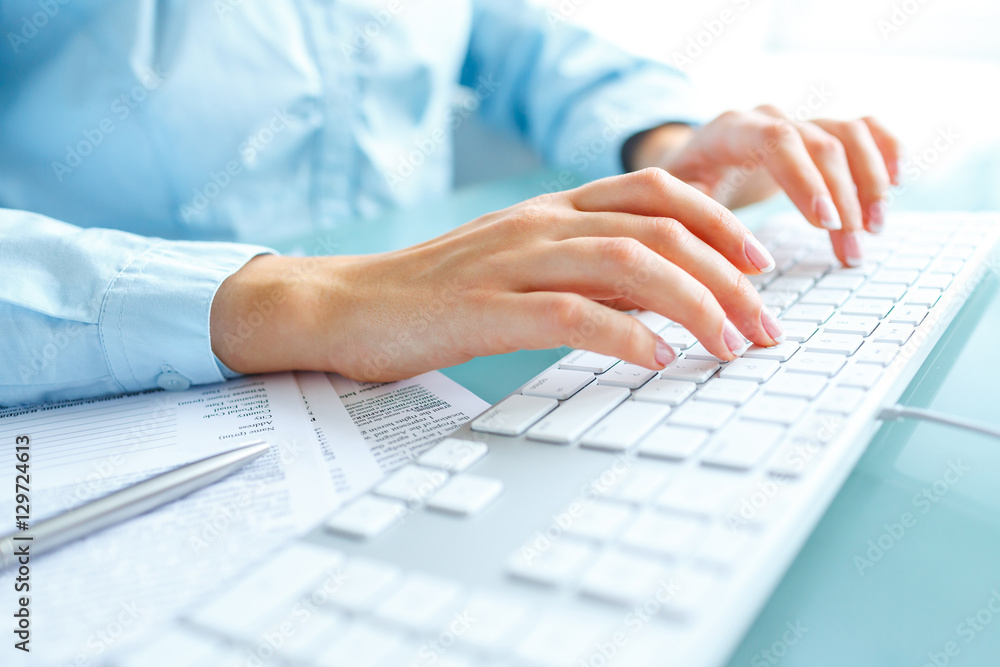 Woman office worker typing on the keyboard Woman office worker typing on the keyboard