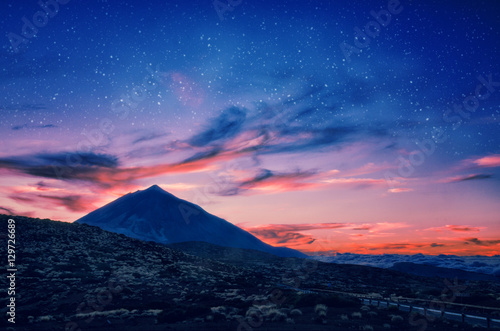 Silhouette of volcano del Teide against a sunset sky. Pico del Teide mountain in El Teide National park at night. Night landscape background with milky way on the sky. Tenerife, Canary Islands, Spain © Betelgejze