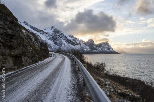 Norwegian landscape with a tiny road along the seaside in a fjord in the winter, Nordland, Norway