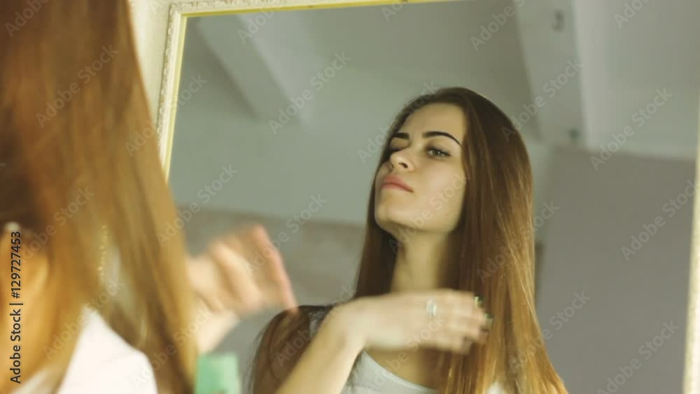 Young adult woman doing makeup by herself Young adult woman doing makeup by herself