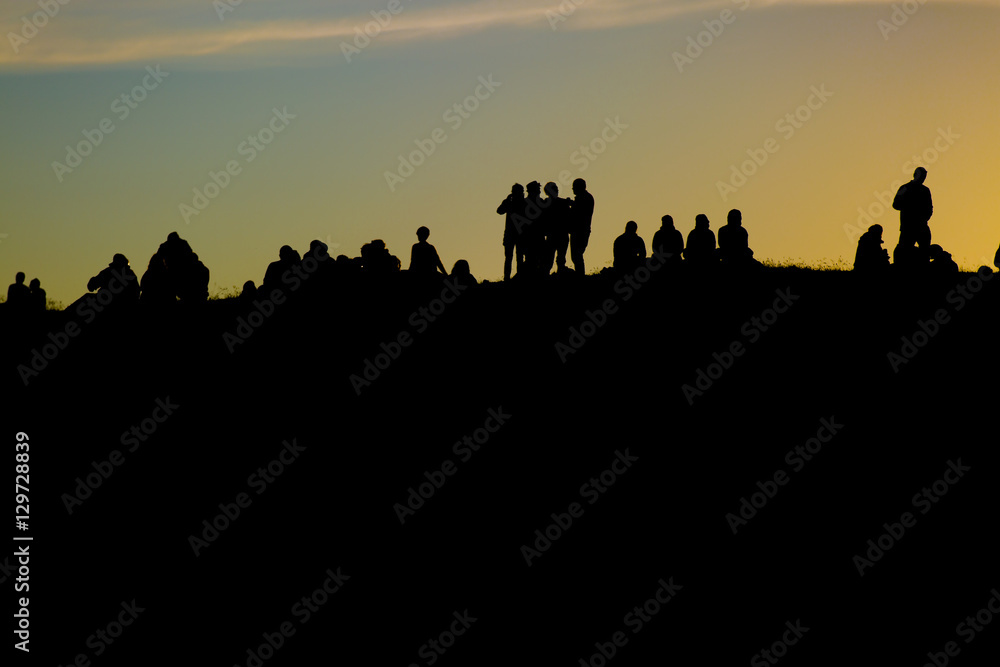 Traena festival 2014, people standing on the top of a hill dmiring the midnight sun