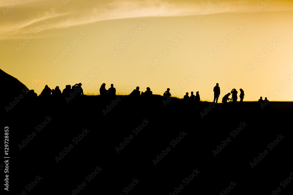 Traena festival 2014, people standing on the top of a hill dmiring the midnight sun