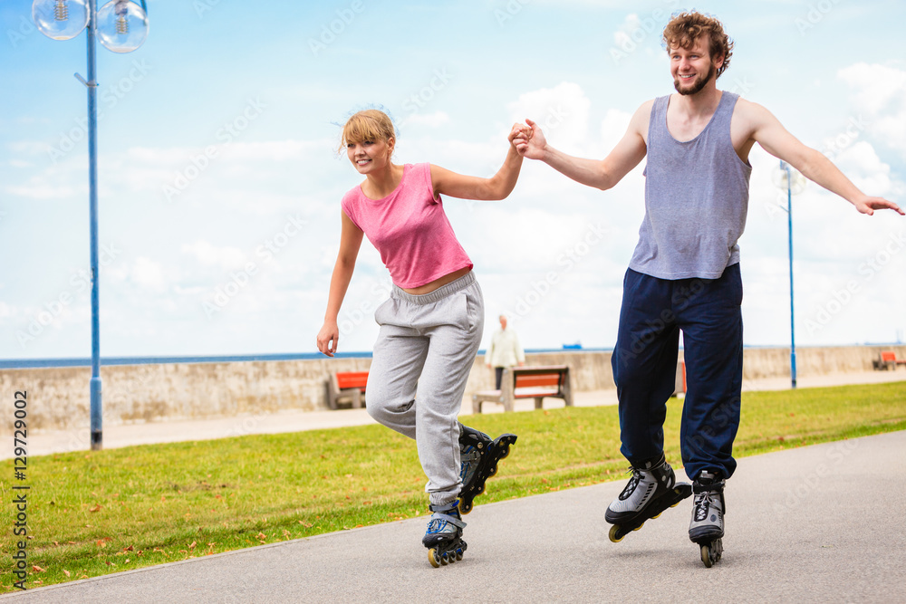 Fototapeta premium Active people friends rollerskating outdoor.