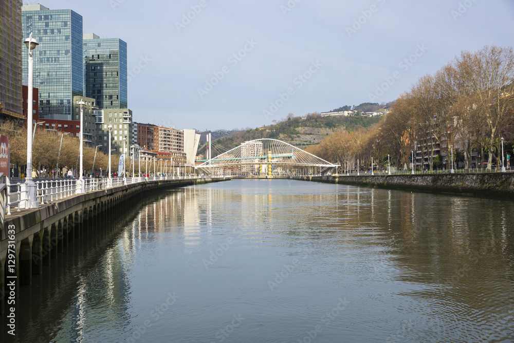 Bilbao, Spain, Nervion river with modern bridge Zubizuri designed by architect Santiago Calatrava. Zubizuri is Basque for white bridge, also called Campo Volantin Bridge or Puente del Campo Volantin.