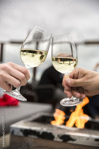Celebration. People holding glasses of white wine making a toast
