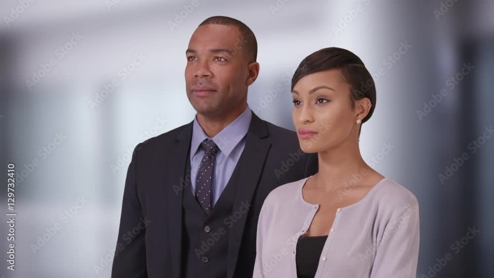 Black business couple posing for a portrait in their office Black business couple posing for a portrait in their office