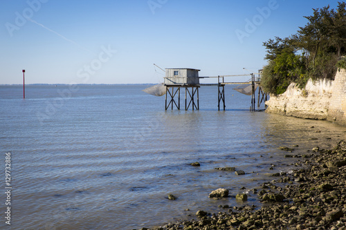 traditional fisherman's wooden hut at the bottom of the limestone cliff in the estuary of Gironde, Talmont