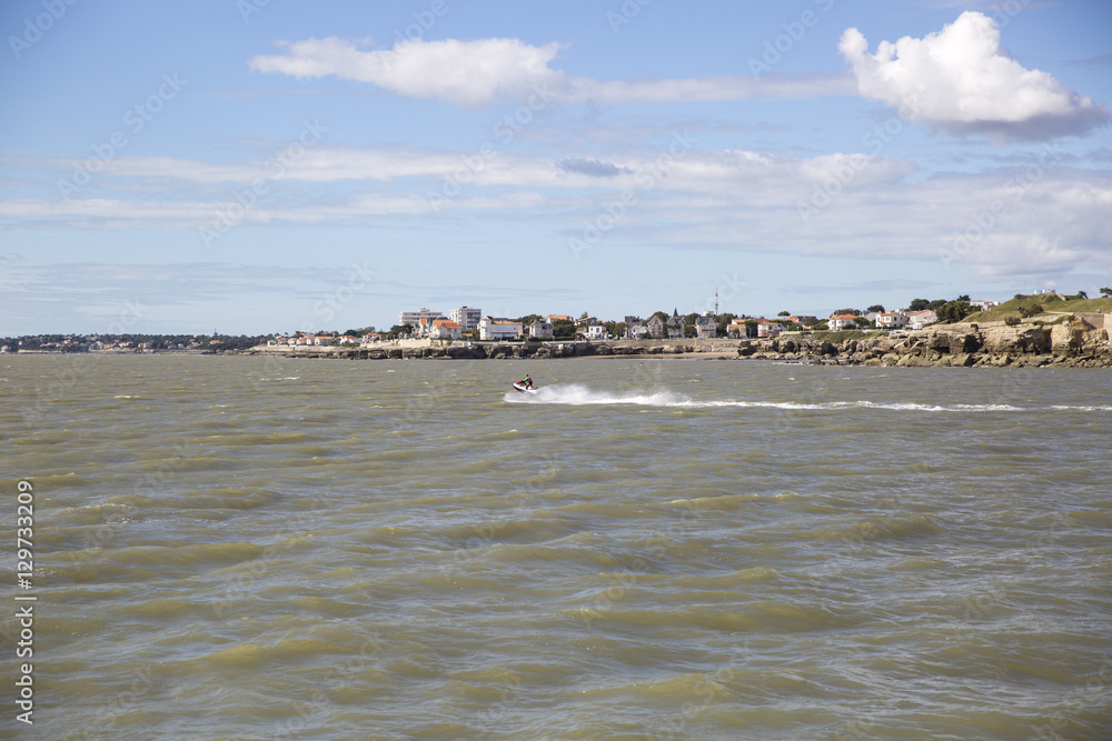 View of the coastline with seaside resort of Royan with blue sky and fluffy white cloud, France