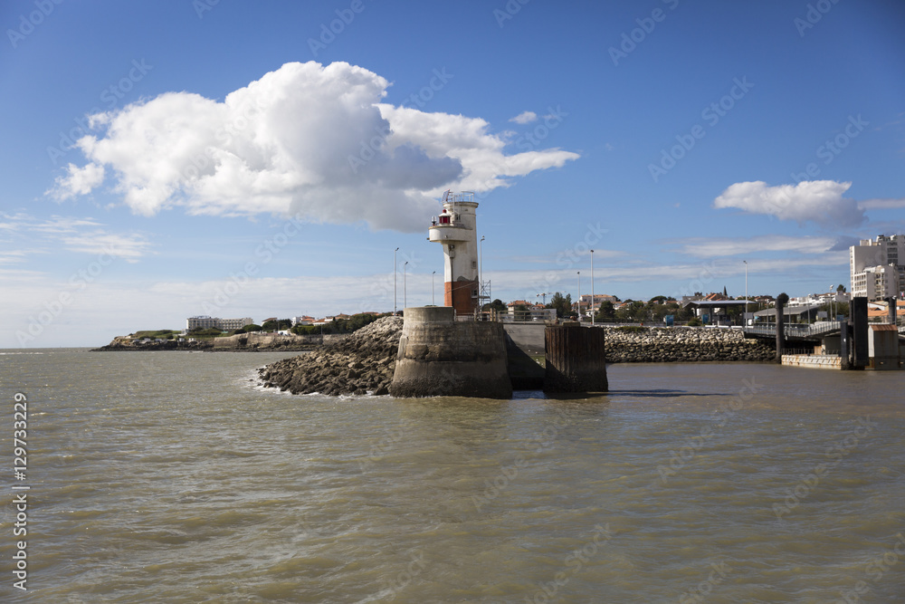 Entrance of port of Royan with small red and white lighthouse, France