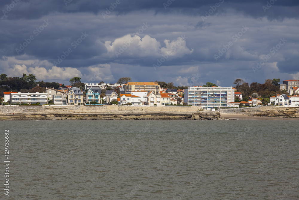View of the coastline with seaside resort of Royan with grey tourmented sky, France
