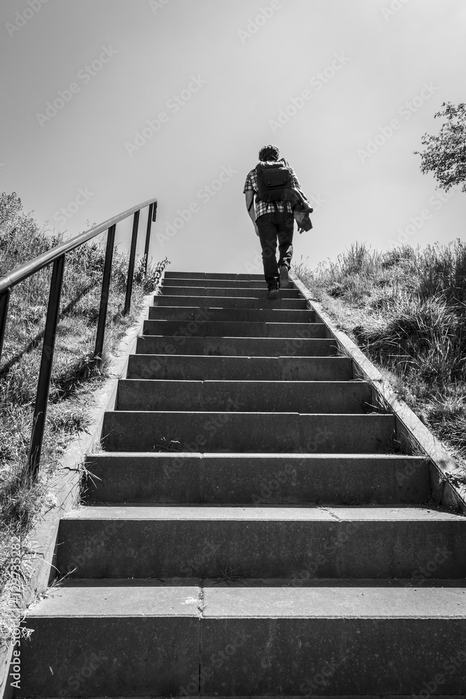 Man walking up stairs, black and white
