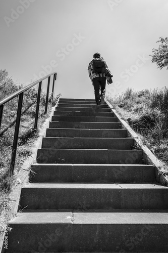 Man walking up stairs, black and white