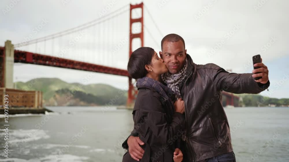 A black couple poses for a picture near the Golden Gate Bridge A black couple poses for a picture near the Golden Gate Bridge