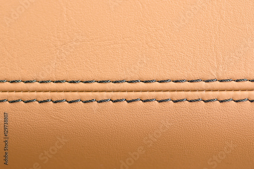 Car leather background with stich. Interior detail. Macro.