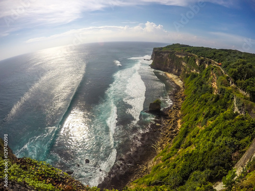 Wide Beautiful view of Cliff, Sea Wave and Sunny with Blue Sky at Bali Island Indonesia
