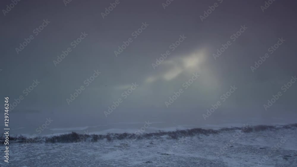 Slow motion - blizzard blowing over frozen pond Slow motion - blizzard blowing over frozen pond