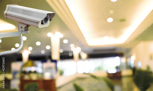 CCTV Camera on abstract blur beautiful hotel lobby background for design.
