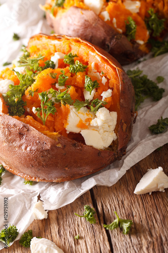 baked sweet potato stuffed with feta cheese and parsley macro. vertical, rustic
