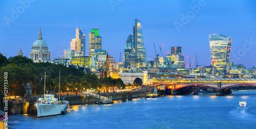 London cityscape at dusk with urban buildings over Thames River © s4svisuals