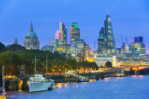 London cityscape at dusk with urban buildings over Thames River