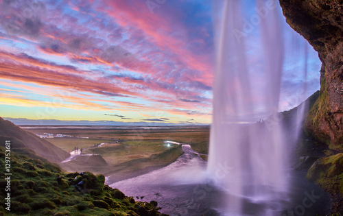 Stunning sunset at seljalandsfoss, iceland with flowing waterfalls