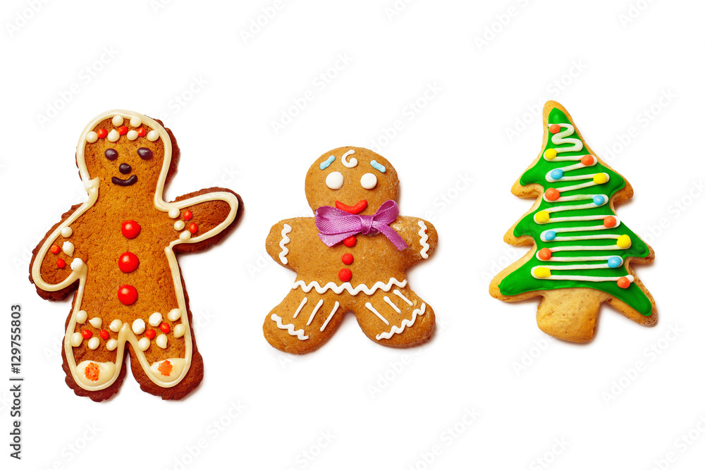 Closeup image of two gingerbread men and christmas tree isolated Closeup image of two gingerbread men and christmas tree isolated