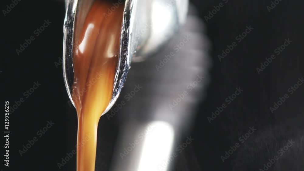 macro shot of coffee extraction and pour from professional coffee machine over black background, 180fps prores footage