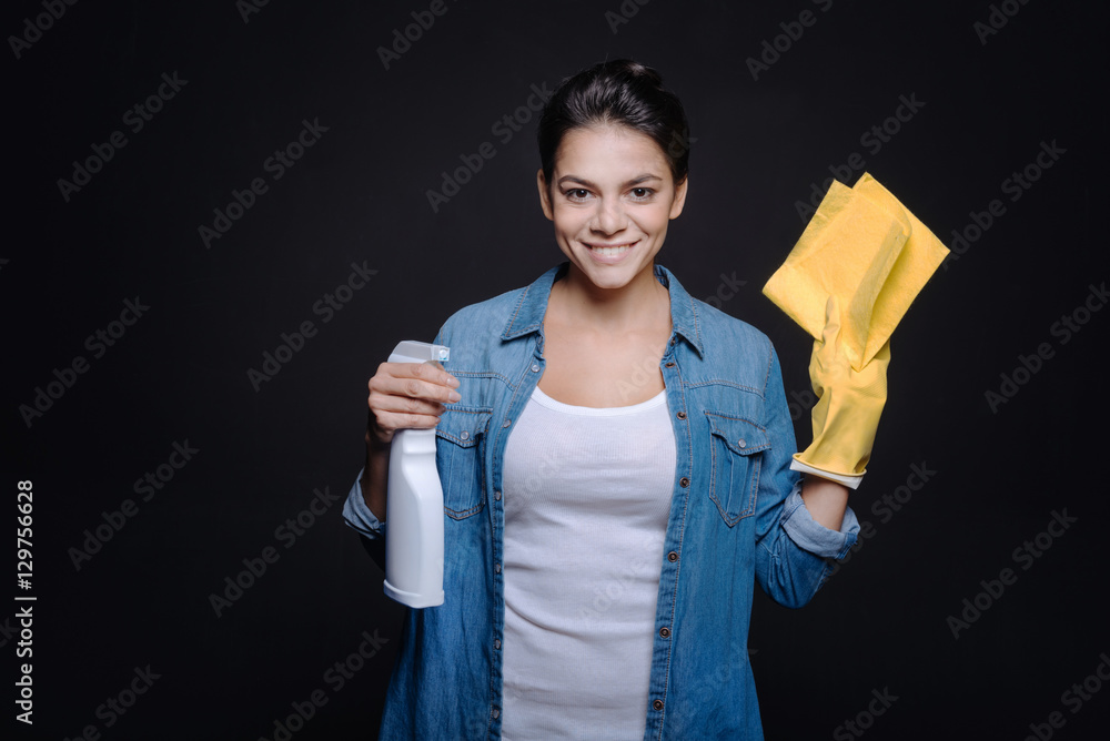 Smiling young woman ready to clean the house Smiling young woman ready to clean the house