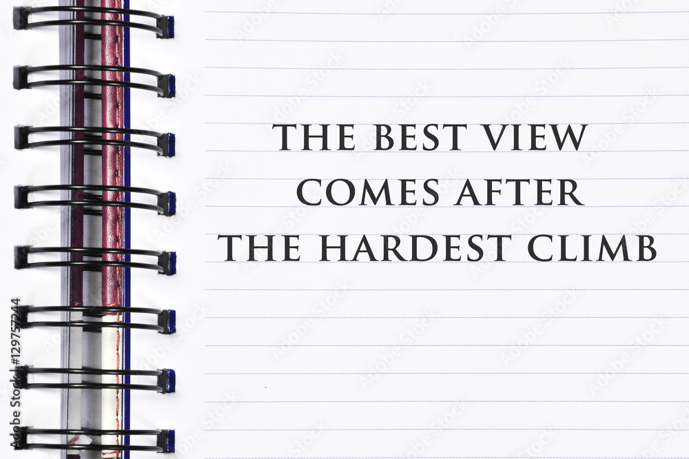 Inspirational motivating quote on spring white note book. the best view comes after the hardest climb.