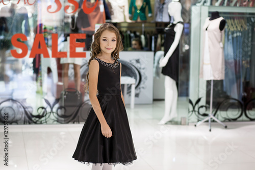 Girl on the background of shop windows